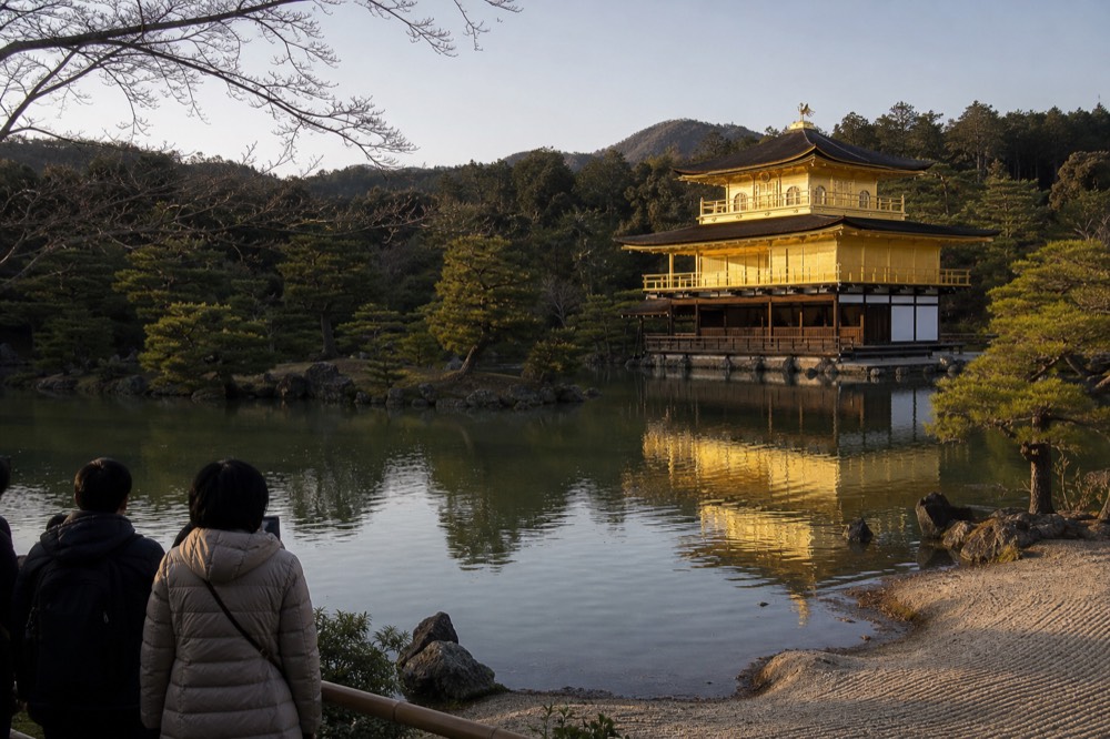 The Golden Pavilion seen across the Mirror Pond with its gold-leafed upper floors catching morning light
