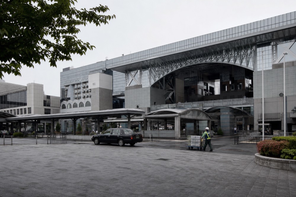 The front of a Kyoto railway station concourse with departure boards overhead