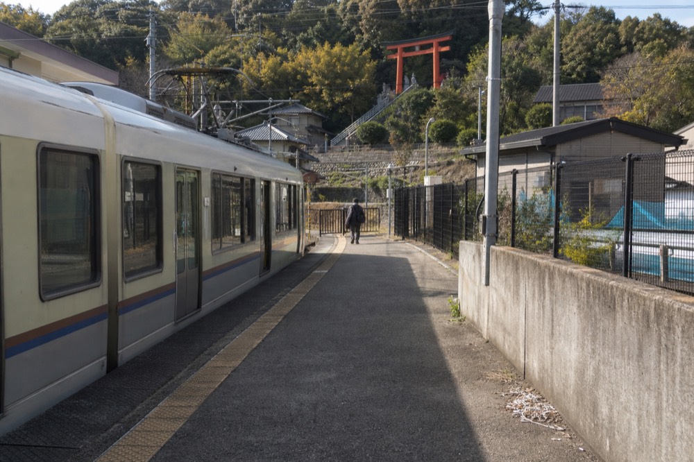 A clean local train at a small suburban station platform south of Kyoto