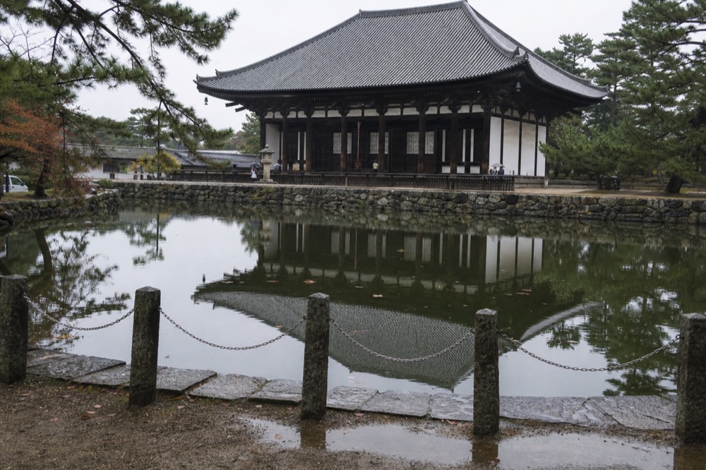 Temple hall with a large roof beside a pond in Nara