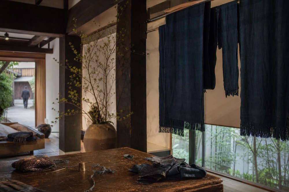 Indigo dyed cloth hanging inside a small traditional craft shop