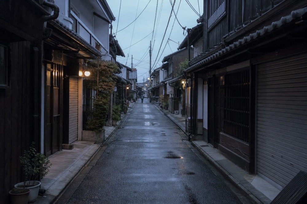 Quiet narrow lane between old wooden buildings in early morning