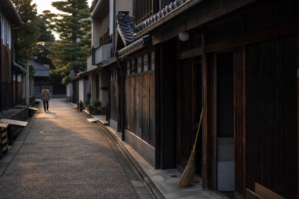 A narrow old street with traditional wooden merchant houses